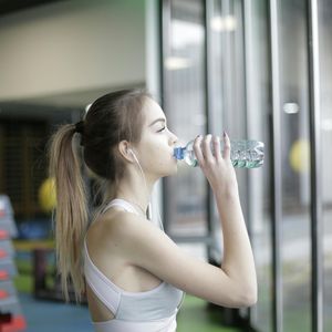 Selective focus on a water bottle in a gym setting